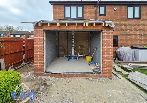 Views of a newly constructed extension shell, the doors and roof are yet to be built.