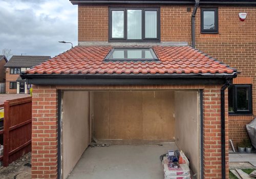 Views of a newly constructed extension shell, the doors and roof are yet to be built.